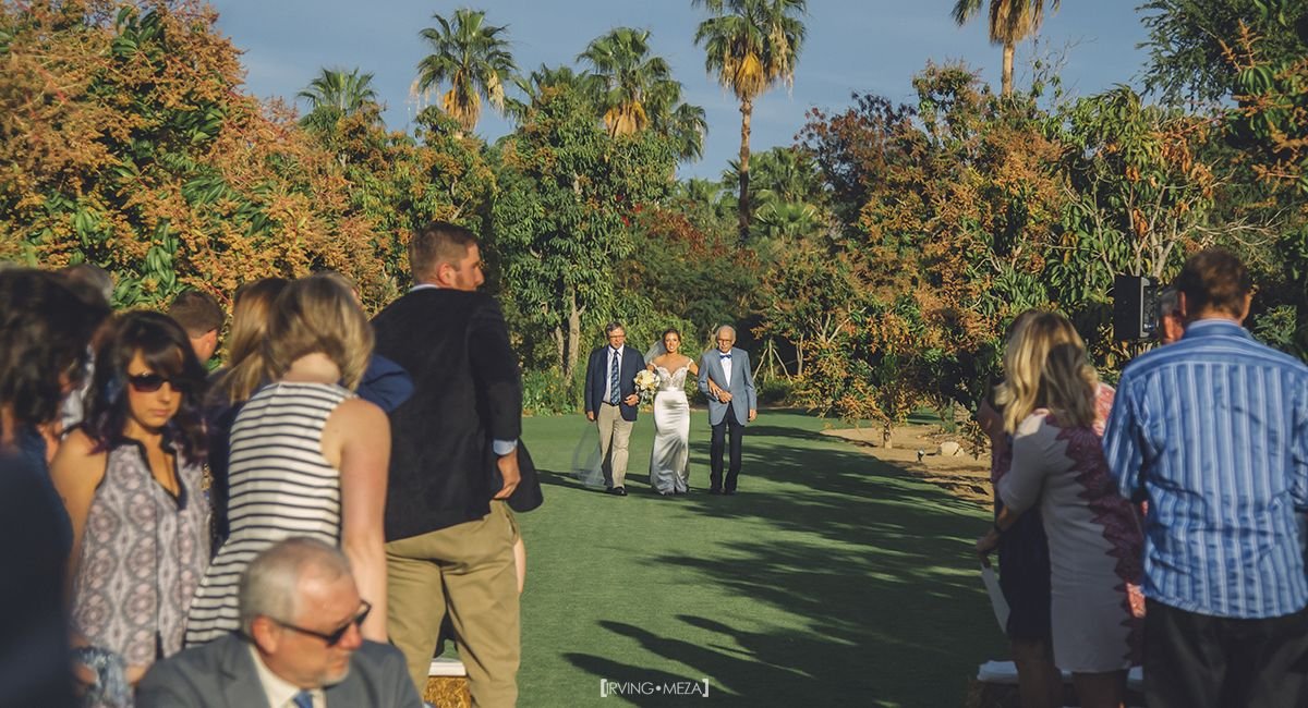 Bride meeting her grandfather in the middle of the aisle at Wedding Venue Flora Farms in Cabo San Lucas Mexico