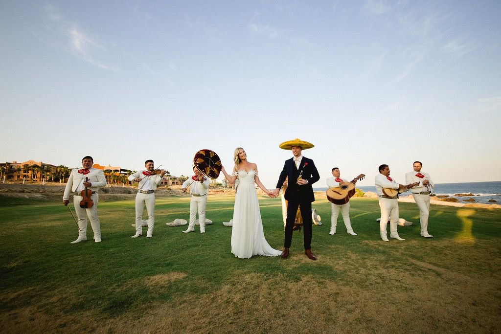 Bride and Groom taking photos with the mariachi band that played during their cocktail hour on their wedding day. Oliver was able to grab a sombrero and use it to take a picture. Epic!