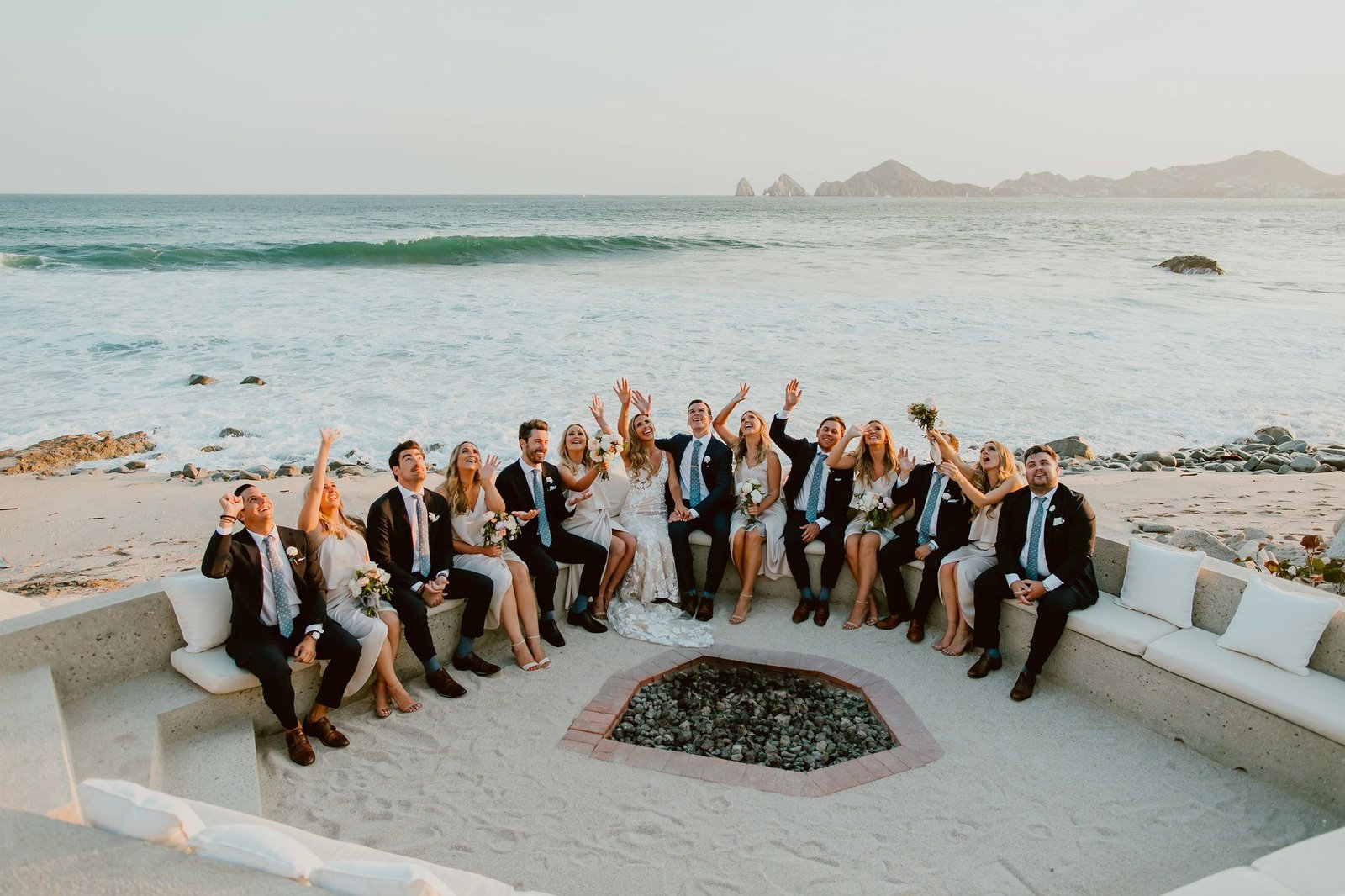 Photo Session with the Bride and Groom at the fire pit on the Beach at The Cape Hotel in Cabo San Lucas Mexico. The famous Arch behind them as well as the Sea of Cortez made everything perfect. The waves also looked amazing.