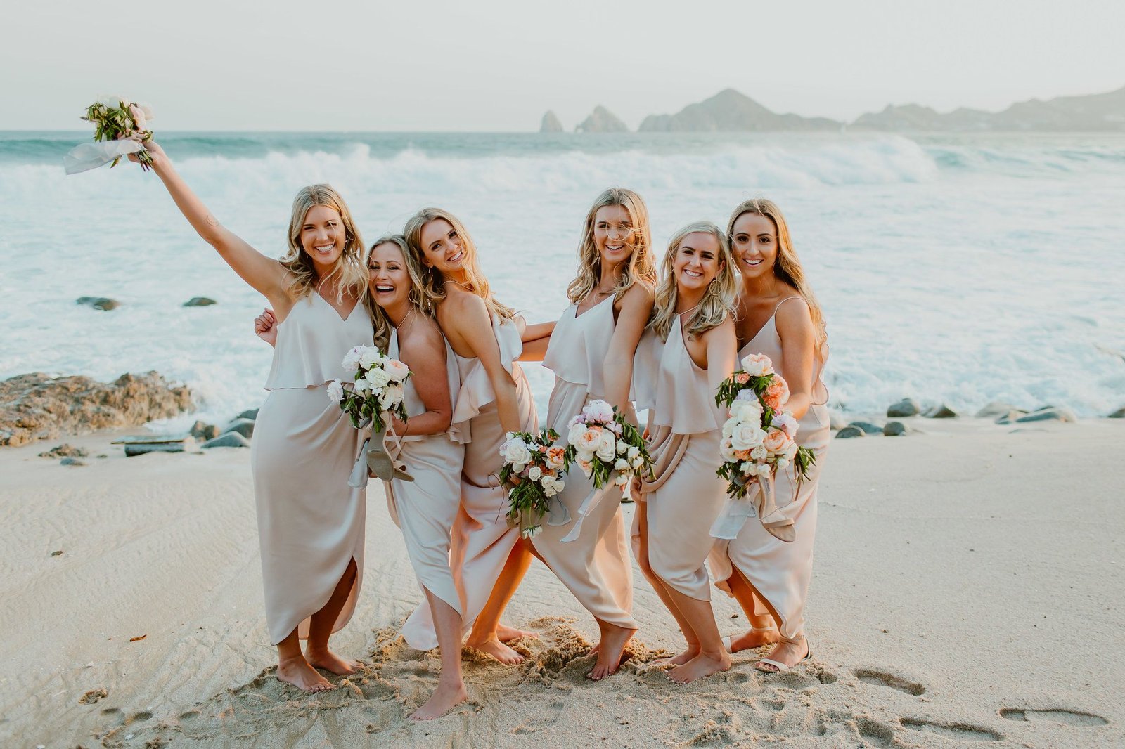 Bridesmaids having fun infront of the Sea of Cortez at Dana and JJ´s wedding in Los Cabos Mexico. Photography by Ana and Jerome. Wedding Planning by Cabo Wedding Services