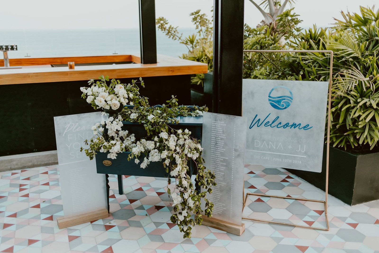 Welcome Table at the Rooftop at the Cape by Thompson Hotels. Details of Escort Table and Welcome sign by bells and whistles in Los Cabos Mexico. Wedding Planning by Cabo Wedding Services