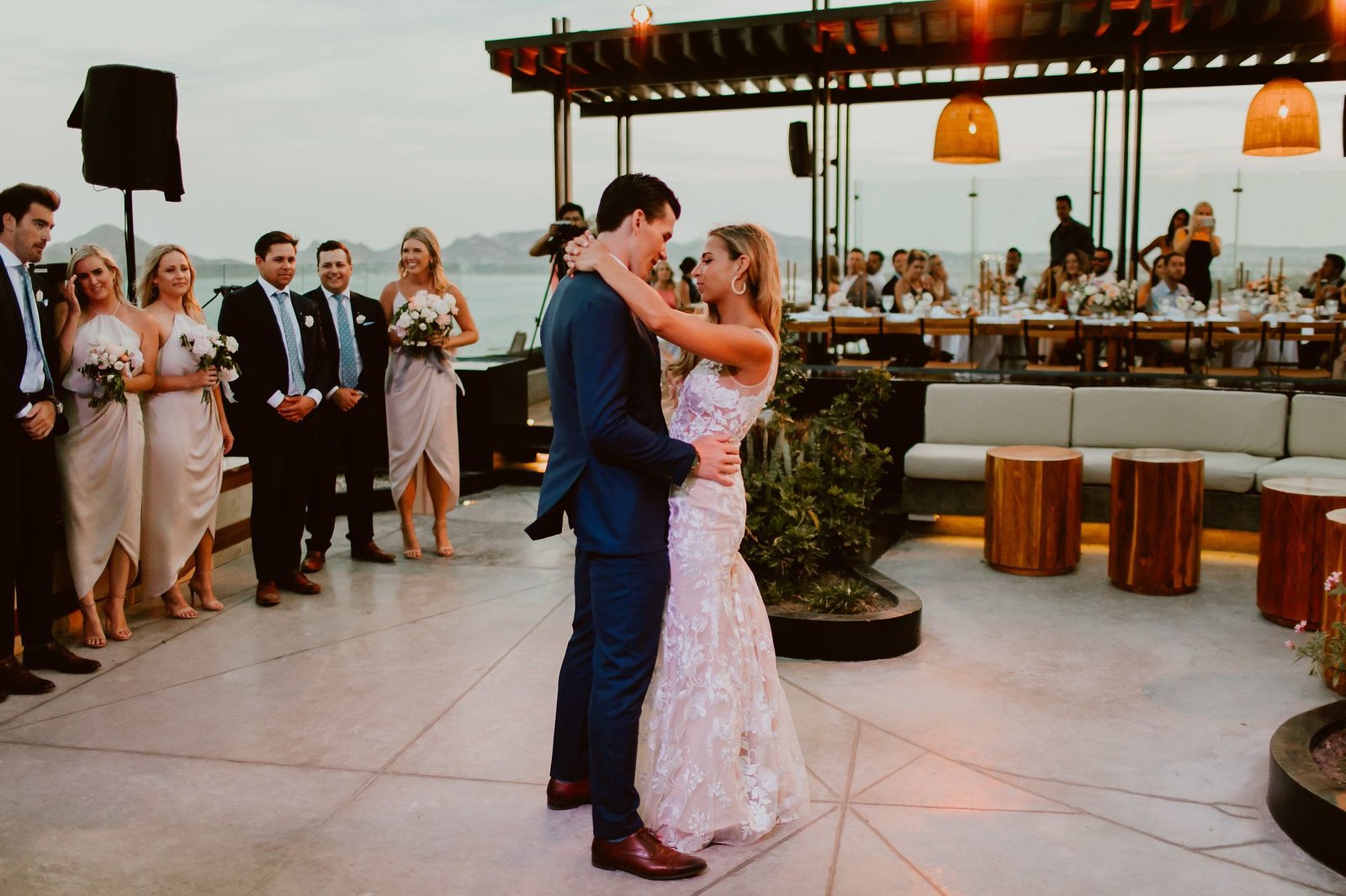Bride and groom having their first dance at the rooftop at The Cape in Los Cabos, Mexico. They had all of their close family and friends watching as they has their first dance as husband and wife.