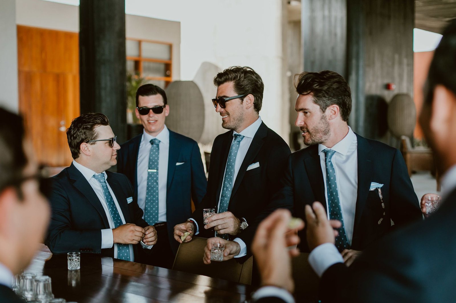 The groom and groomsmen having a shot right before the ceremony begins. This photo was taken at the Lobby bar at The Cape by THompson Hotels in Cabo San Lucas. Wedding Planning was done by Cabo Wedding Services.