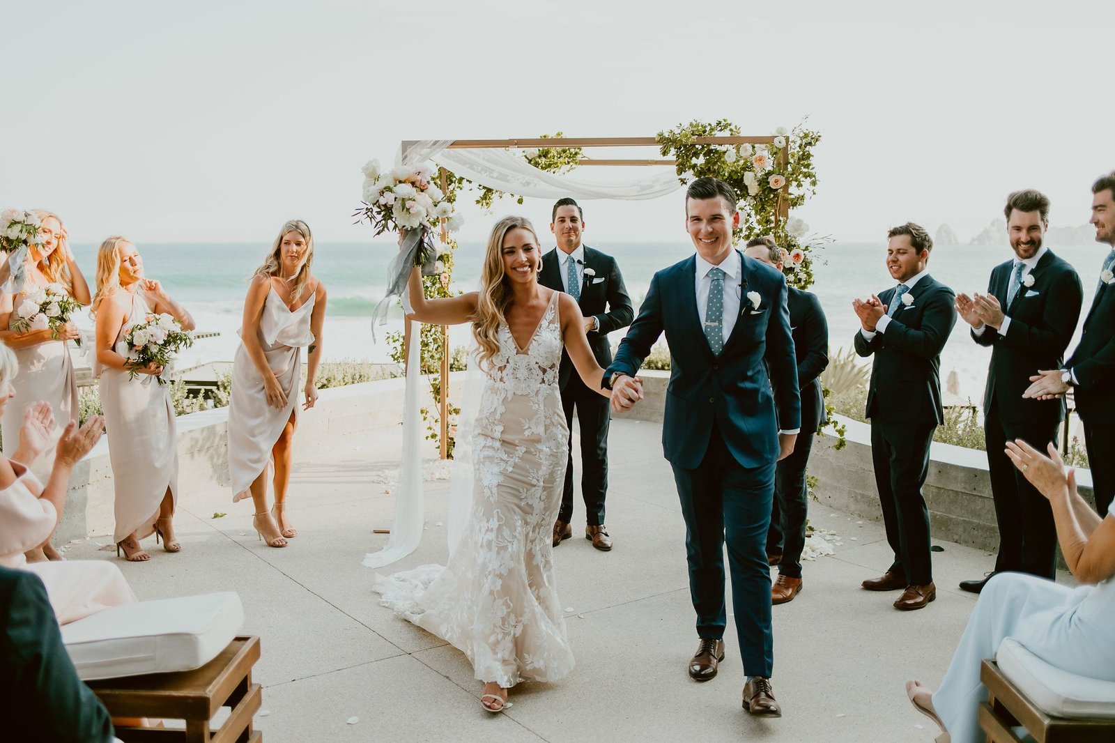 Bride and Groom recessional after their ceremony at The Cape Terrace in Los Cabos. Beautiful Dress made by Made with Love Bridal. Perfect design for a perfect bride! Wedding Planning by Cabo Wedding Services