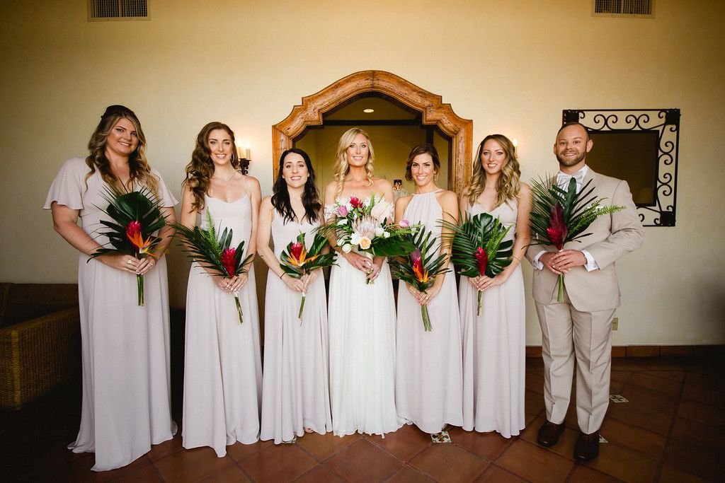 Bride all ready with her Bridesmaids minutes before walking down the Aisle to get married. They all have beautiful tropical bouquets, designed and planned by Cabo Wedding Services