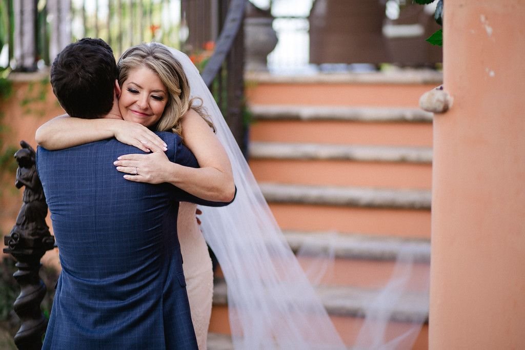 Bride and Groom hugging after doing First Look at Cabo del Sol in Cabo San Lucas, Mexico. They were married at a Villa and had a Villa Wedding inside the cabo del Sol complex. Wedding Planning was done by Cabo Wedding Services