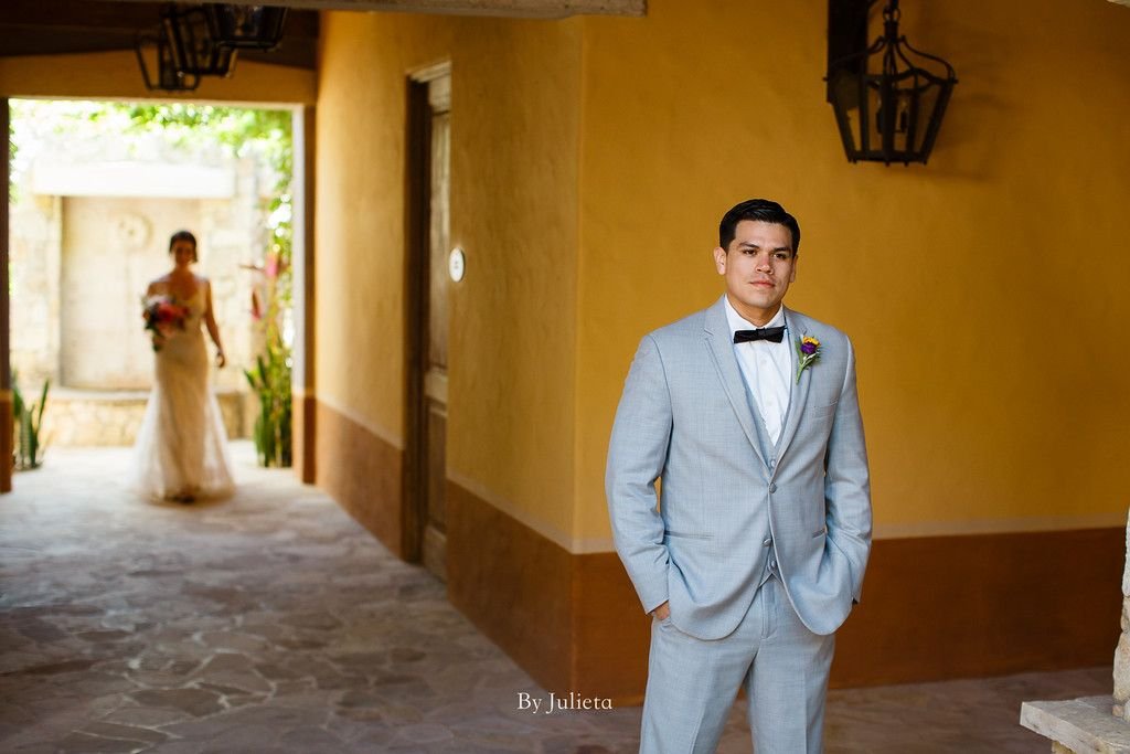 Bride walking behind the groom at Hacienda Cocina and Cantina moments before the Ceremony. Julieta Amezcua was able to take the best photos of this couple in Los Cabos, Mexico. 