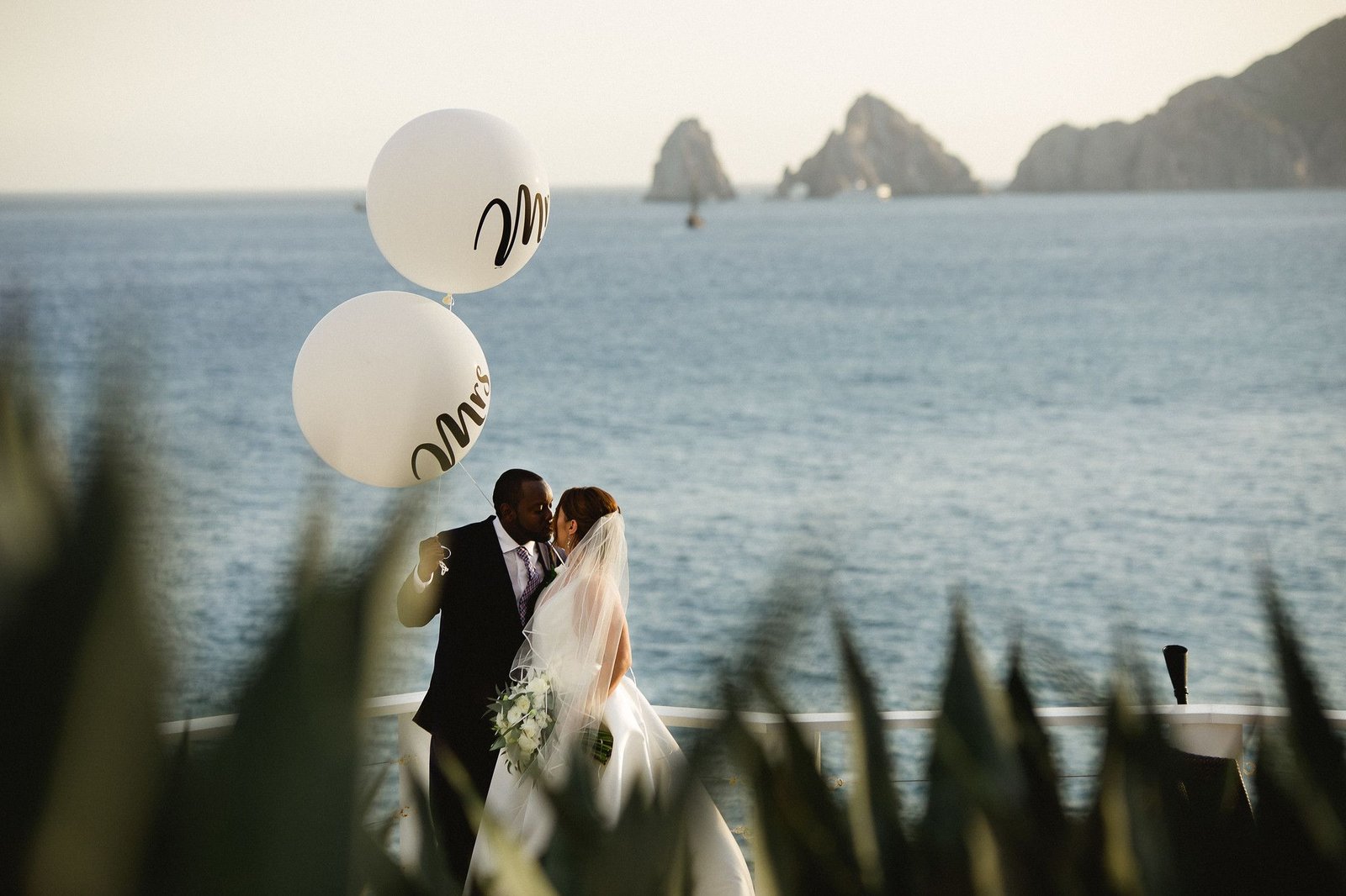 Bride and groom over looking the Sea of Cortez and the Arch in Los Cabos Mexico on their wedding day at Sunset da Mona Lisa located in Cabo San Lucas. Wedding Planning and design by Cabo Wedding Services