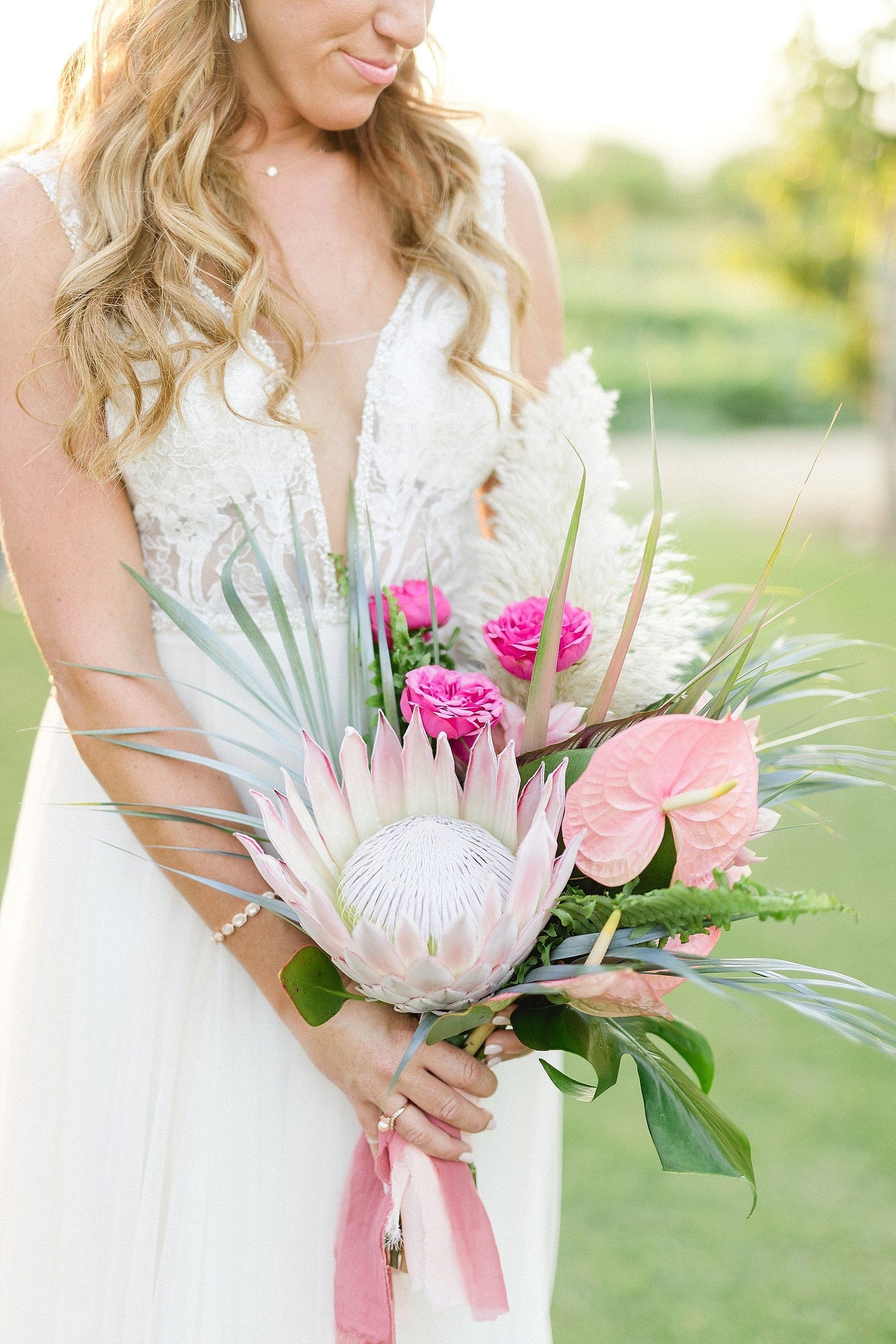 Bridal Bouquet with Proteas and Anthuriums. Wedding Venue at Flora Farms in Los Cabos, Mexico. Wedding Planning by Cabo Wedding Services and Wedding Photography by Sara Richardson