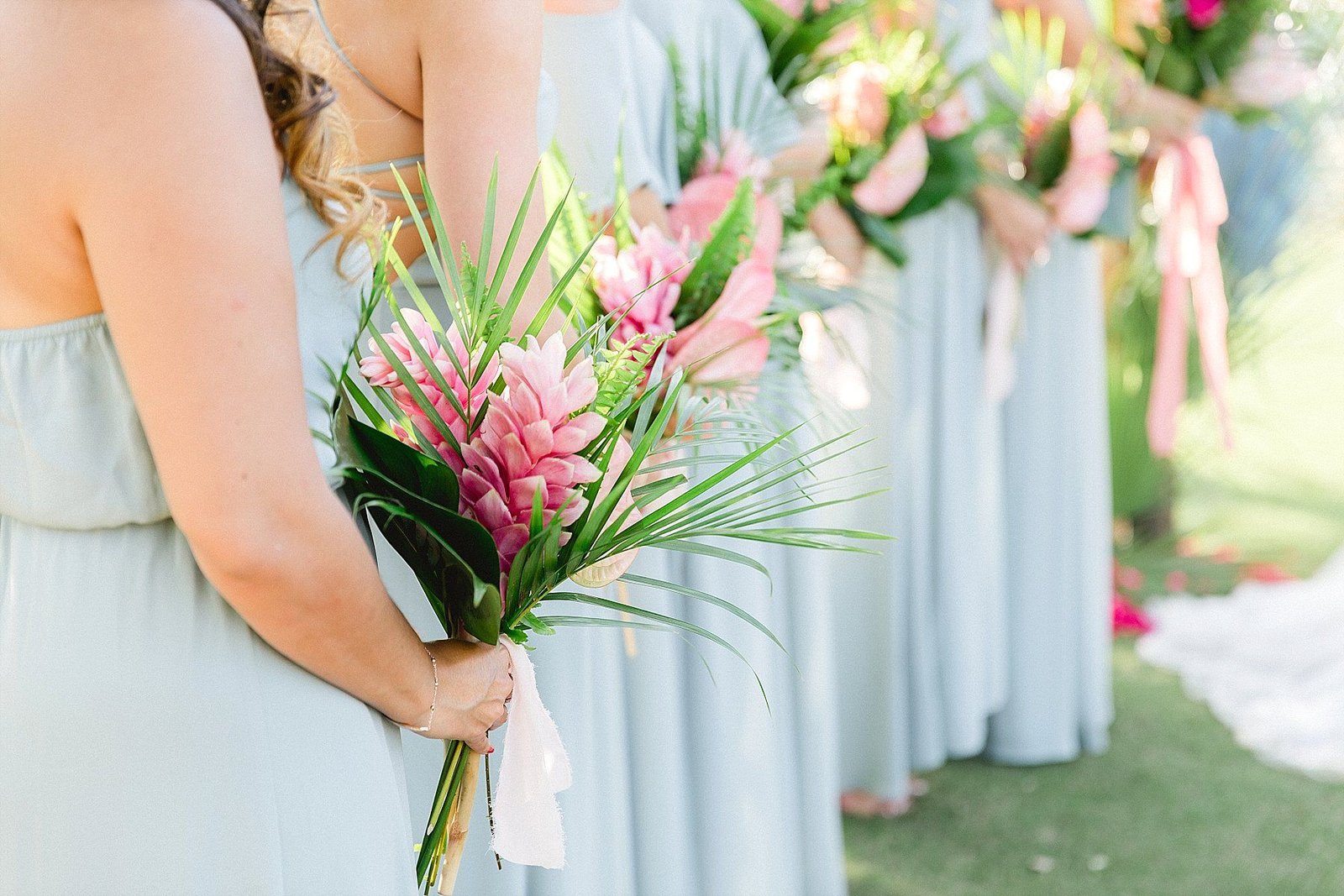 Bridesmaids lined up during the Ceremony at Wedding Venue Flora Farms in Los Cabos Mexico. Wedding Planning by Cabo Wedding Services and Wedding Photography by Sara Richardson