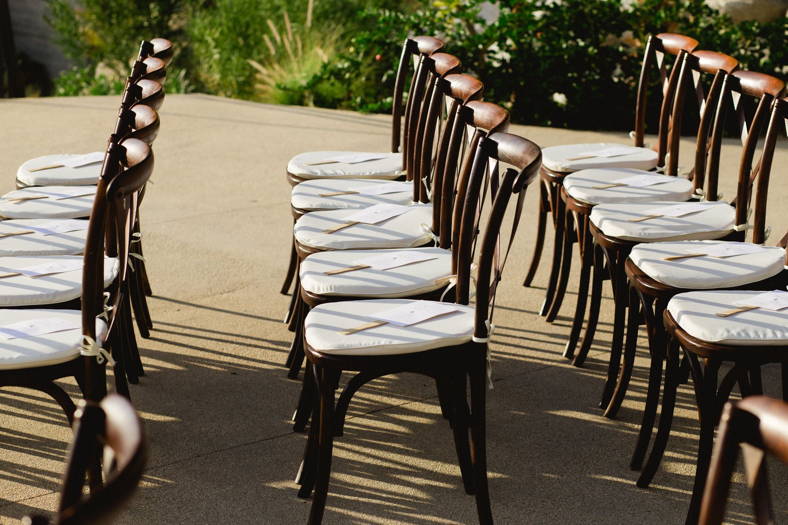 Ceremony Chairs at the Cape in Los Cabos Mexico. This was at Ashley and Matthews Wedding at The Cape. They decided to turn their wedding ceremonies in to a fan, in case their guests got hot, they had something to cool down with