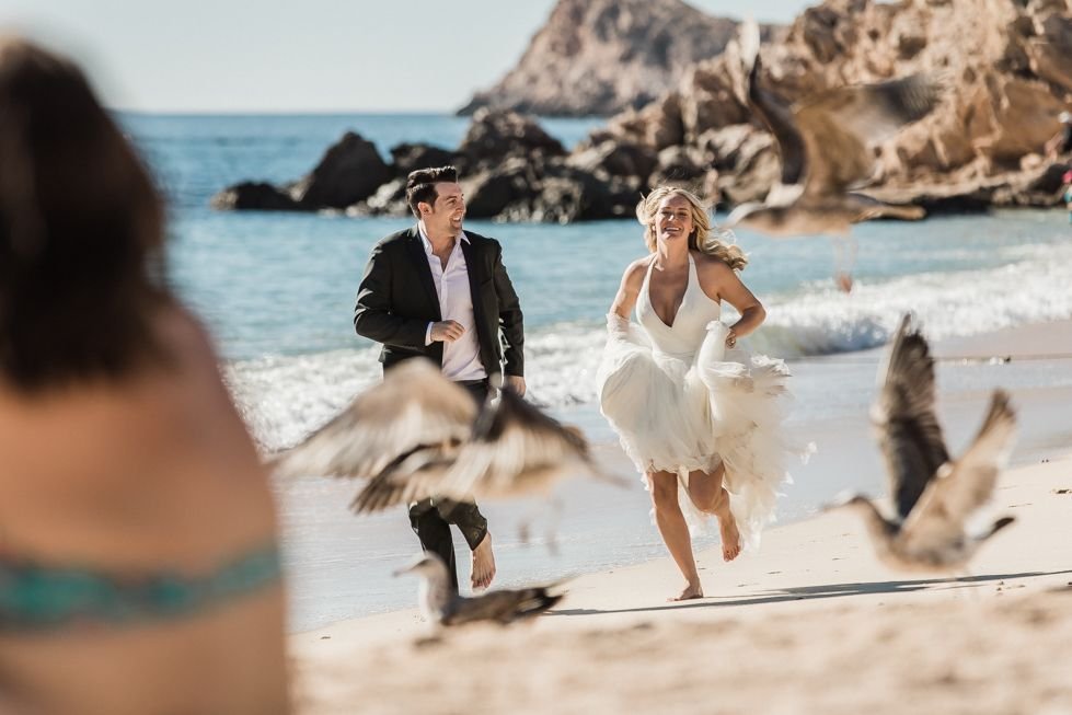 Bride and Groom running during their photo session at the beach the day after their wedding. They decided to go with Local Photographer Daniel Jireh. Wedding Planning done by Jesse Wolff at Cabo Wedding Services.