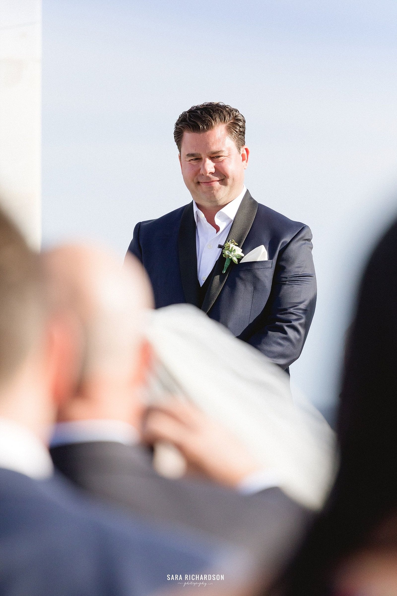 Groom waiting for the Bride as she walks down the aisle for the Ceremony. This wedding was taken place at LeBlanc in Los Cabos Mexico. Photography by Sara Richardson, wedding design by Jesse Wolff