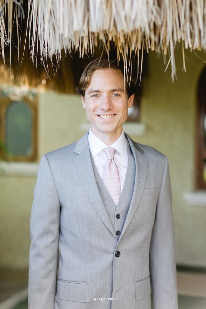 Groom posing for the camera on his wedding day. He got married in Los Cabos, Mexico, at Villa la Roca. He wore Hugo Boss for his suit and looked amazing. 