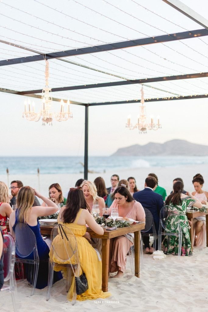 Guests eating at a Beach Wedding in Los Cabos Mexico. Wedding Planning was done by Cabo Wedding services and Catering was done by Lazy Gourmet