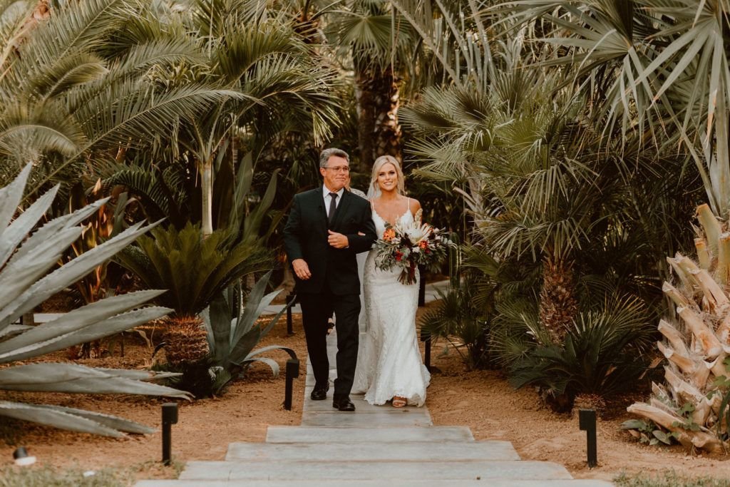 Bride walking the aisle down at Destination Wedding Venue Acre in Los Cabos Mexico. This wedding took place in October of 2019 and Jessica Wolff from Cabo Wedding Services was her Wedding Planner. Her wedding Photographers were Ana and Jerome.