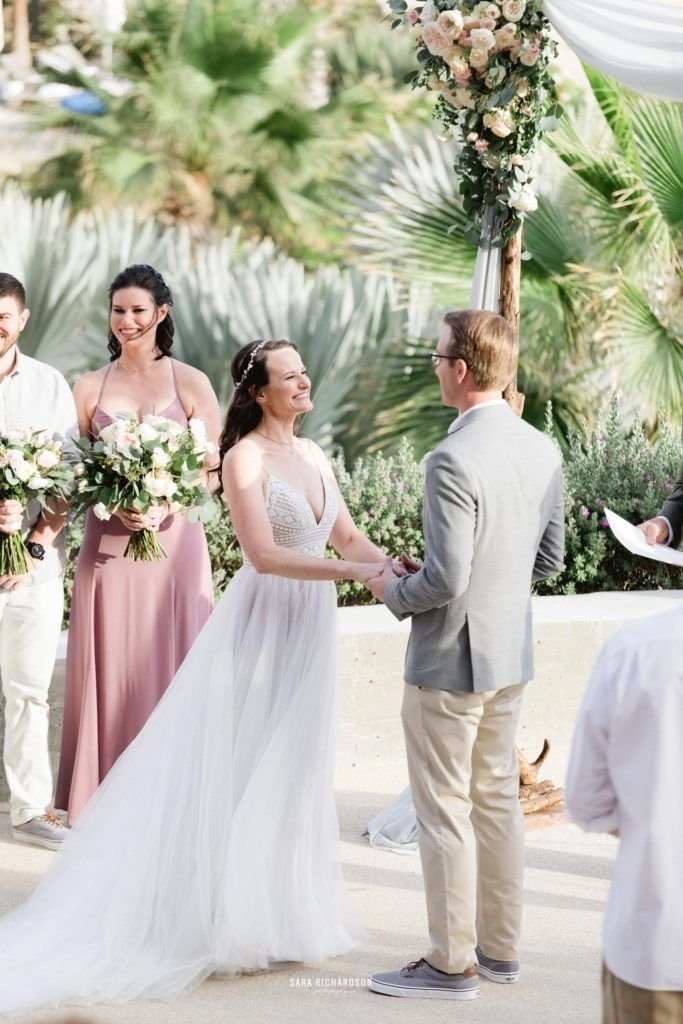 Bride and Groom getting Married at The Cape in Los Cabos Mexico. They are standing in front of the Sea of Cortez and the world renown Arch in Los Cabos Mexico. Wedding planning was done by Cabo Wedding Services by Jesse Wolff