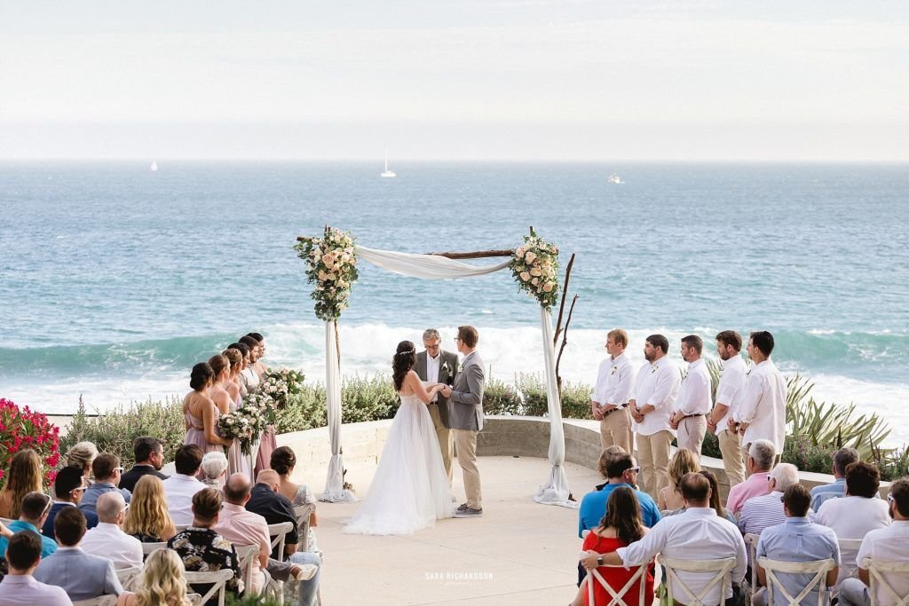 Ceremony happening at The Cape in Los Cabos Mexico. Wedding Planning was done by Cabo Wedding Services by Jesse Wolff