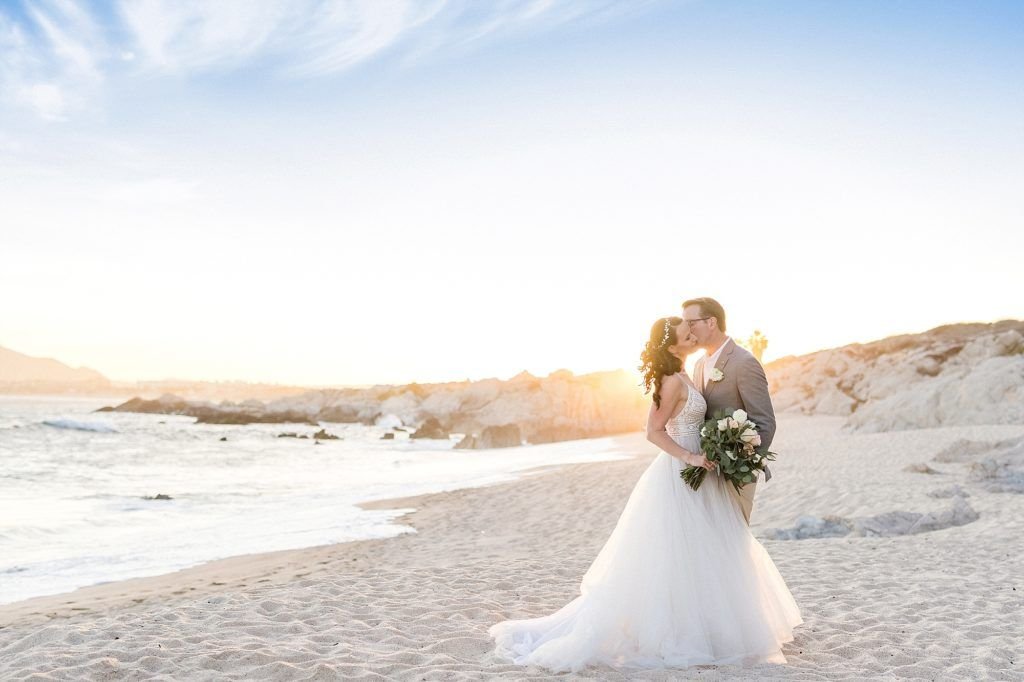 Bride and Groom doing a Photo Session in Cabo San Lucas, Mexico, right infant of The Cape, after their Wedding Ceremony. Wedding Planning by Cabo Wedding Services 