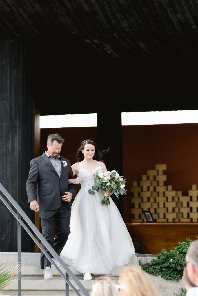 Bride walking down with her dad at The Cape in Los Cabos Mexico. Wedding Planning done by Cabo Wedding Services 