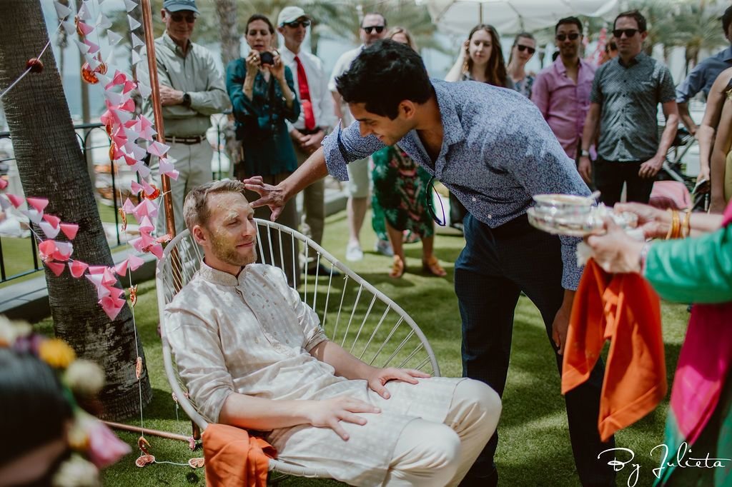 Guests came up to the Bride and Groom and put turmeric on them to cleanse. It was part of the Haldi ceremony at the Hilton Los Cabos.