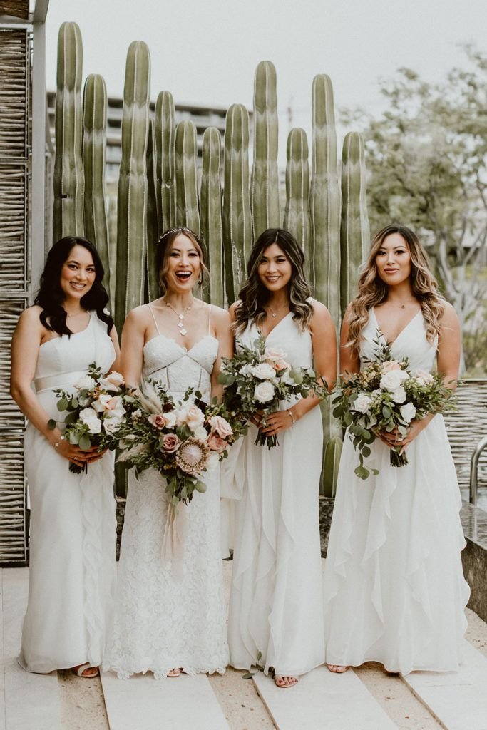 Bride holding her Bridal Bouquet with her Bridesmaids. Beautiful flower design by Let it Be. Wedding venue was at Solaz Luxury Resorts.