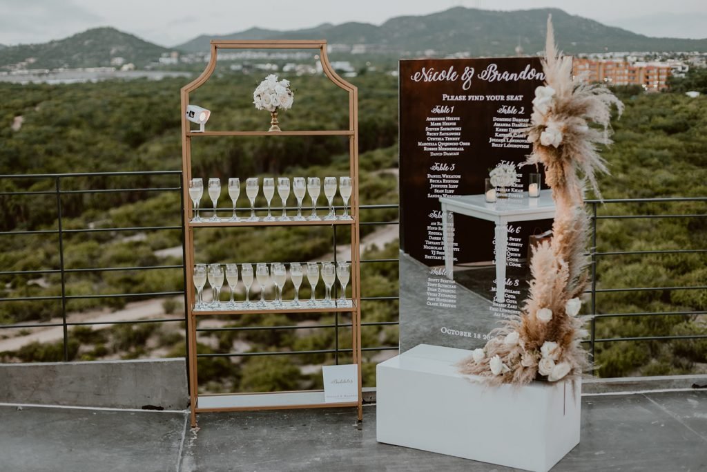 We had a champagne stand, where their guests would find their name, the table they were sitting at and a glass of champagne. this was made by The Main Event in Los Cabos Mexico. Wedding planning was done by Cabo Wedding Services.