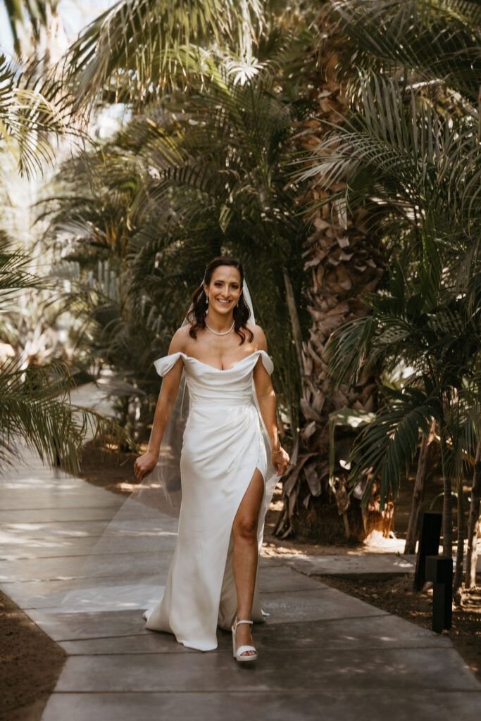 Bride walking towards the first look at Acre Baja
