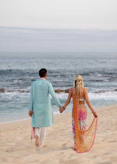 A breathtaking view of a wedding arch on a Cabo beach.